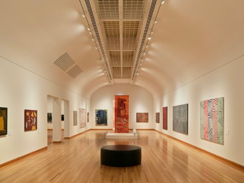 Gallery wall with multiple framed paintings